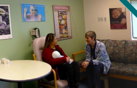 Patient speaking to nurse in breastfeeding clinic
