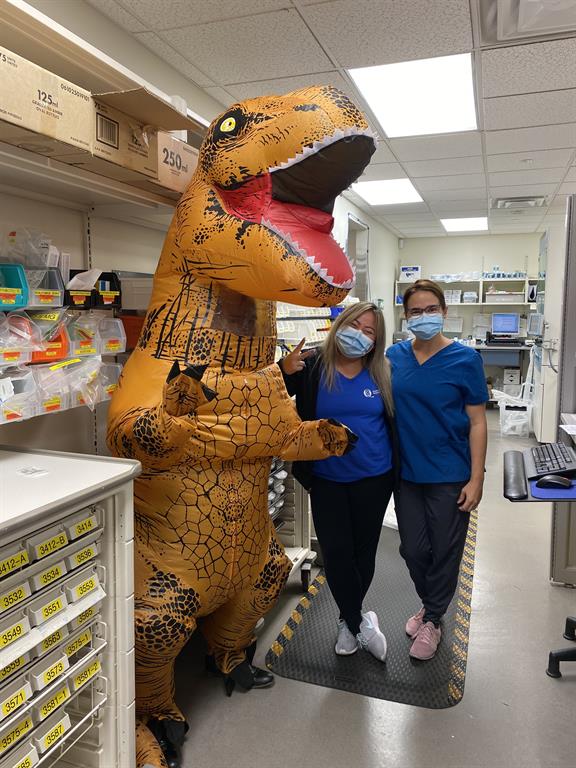 dinosaur with pharmacy staff