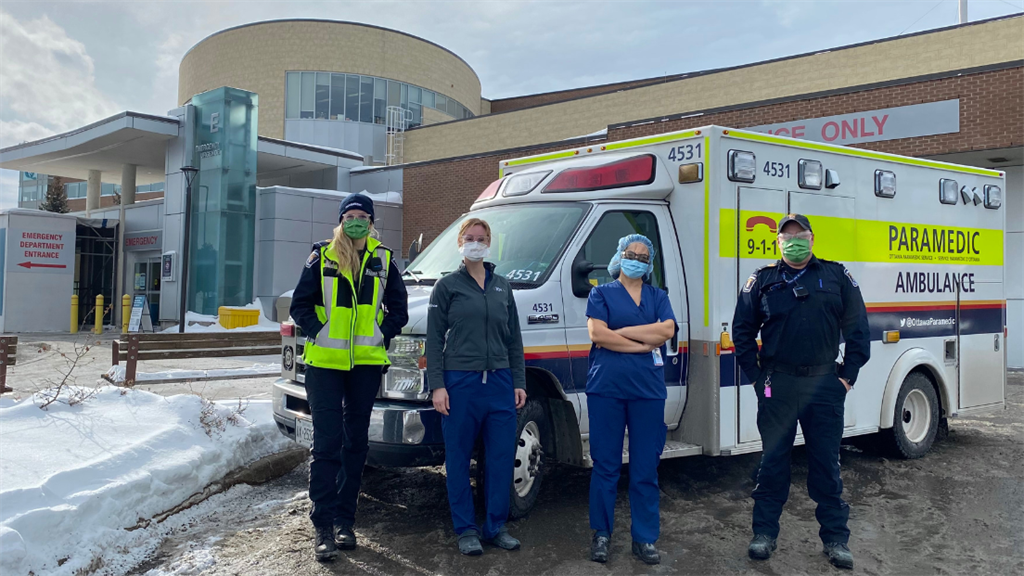 emergency department staff with paramedics outside QCH's emergency department